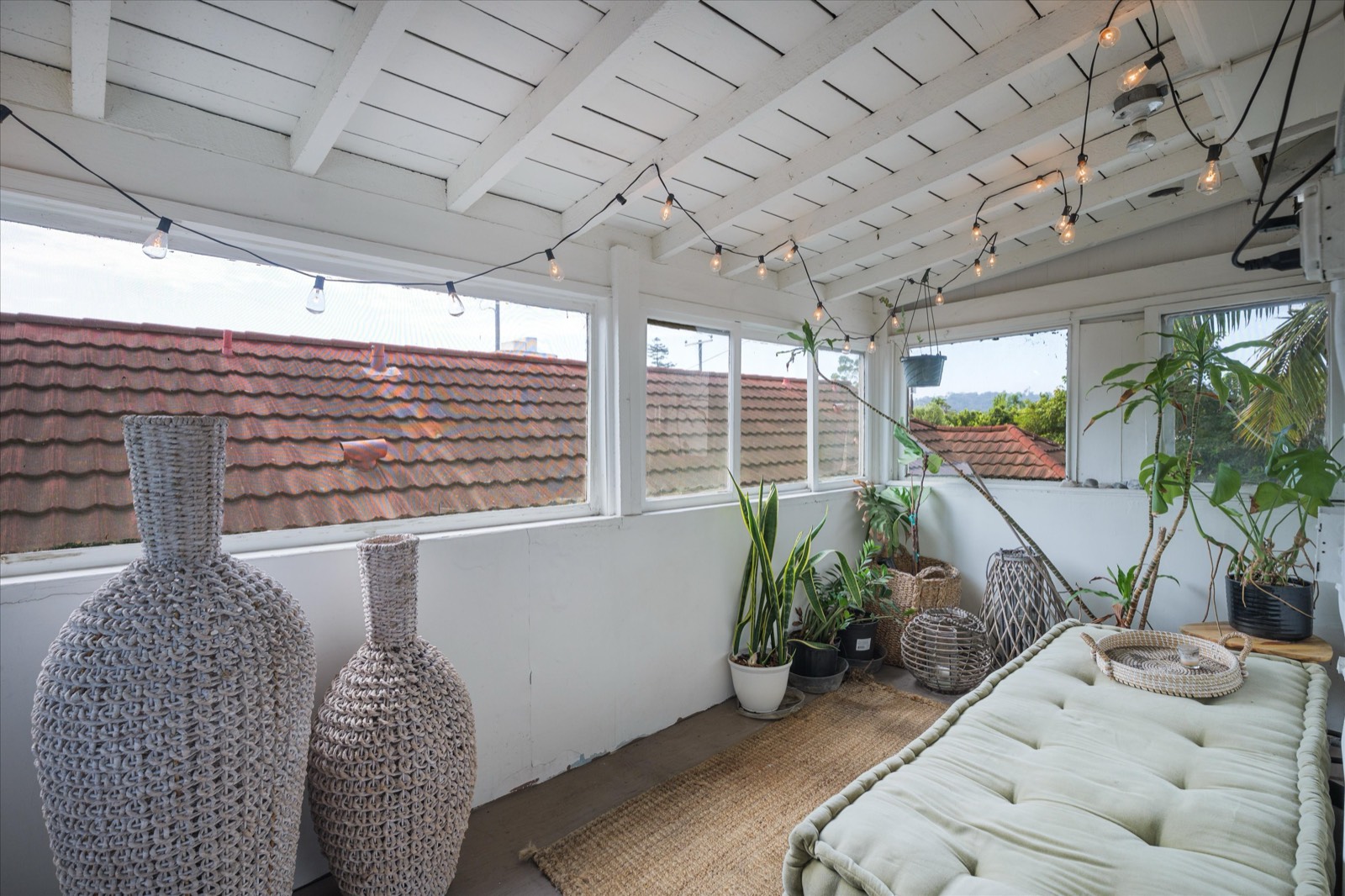 Enclosed sun porch with string lights